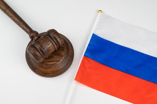 Russian federation flag and judge's gavel on a white table