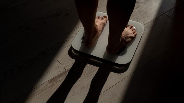 Close-up of female legs on electronic scales