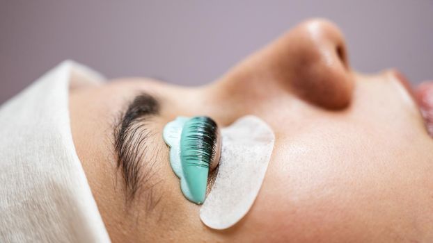 Profile of a woman in a beauty salon on the procedure of eyelash lamination