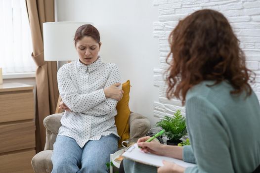 Worried caucasian woman at a session with a psychotherapist