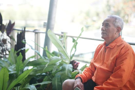 old elderly senior elder man relaxing on terrace. mature retirement lifestyle