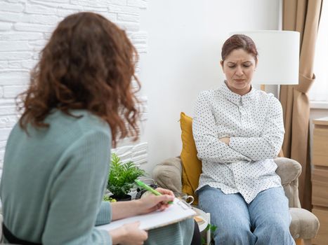 Worried caucasian woman at a session with a psychotherapist