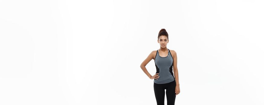 Healthy and Fitness concept - portrait of African American girl posing with fitness clothes over white studio