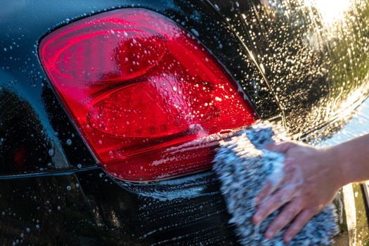 car detailer washing auto with soap