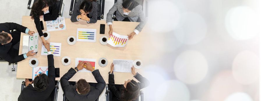 Business people group meeting shot from top view in office . Profession businesswomen, businessmen and office workers working in team conference with project planning document broaden view .