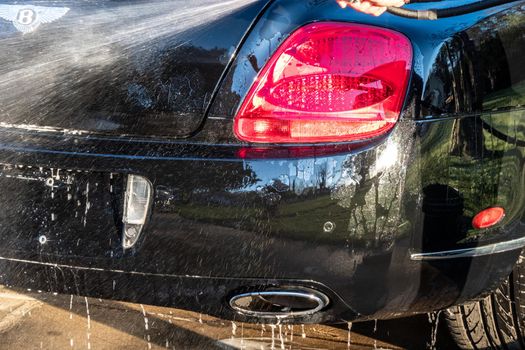 auto detailer washing luxury high end car