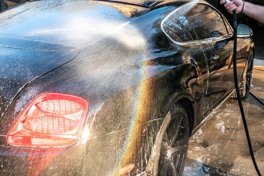 auto detailer washing luxury high end car