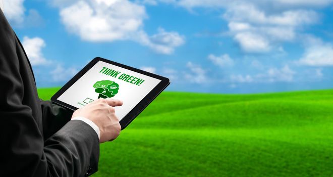 Green business transformation for environment saving and ESG business concept. Businessman using tablet to set corporate goal toward environmental friendly management and alternative clean energy use.