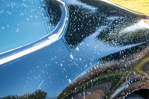 car detailer washing auto with soap