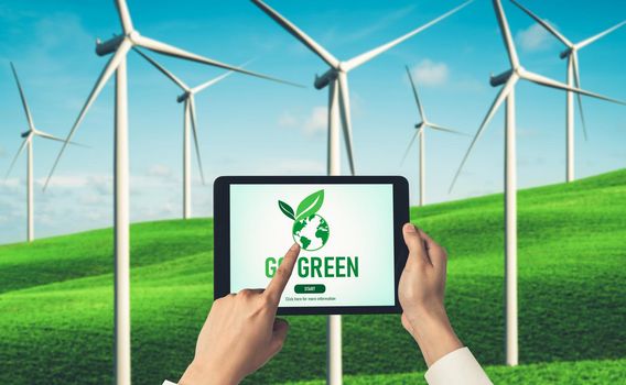 Green business transformation for environment saving and ESG business concept. Businessman using tablet to set corporate goal toward environmental friendly management and alternative clean energy use.