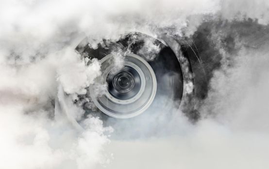 Drag racing car burns rubber off its tires in preparation for the race