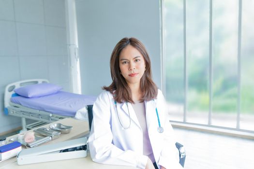 A female doctor works in an office at a hospital or clinic.  Smile and confident woman