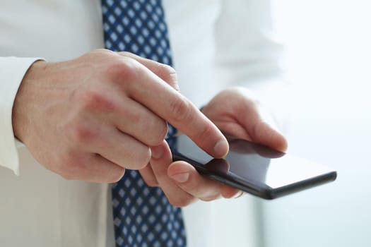 Businessman using phone for celling and texting on her mobile phone