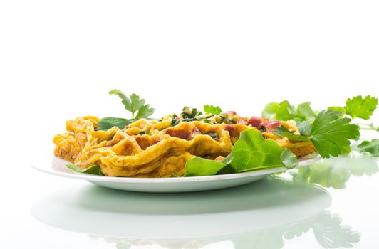 Egg omelet stuffed with greens and sausage fried in the form of waffles, isolated on white background