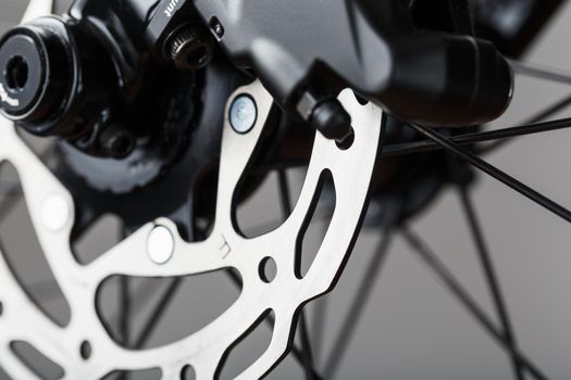 Shiny bicycle brake rotor close-up in macro with selective focus