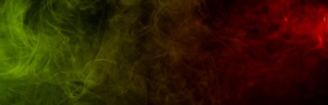 Red yellow green smoke on a black background