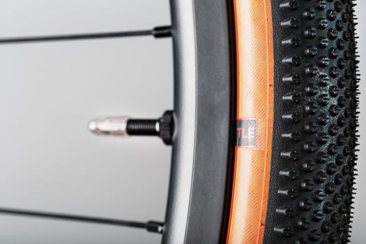 Nipple on bicycle rim for tubeless system close-up on gray background