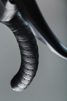 Handlebar winding of a road bike close-up on a gray background