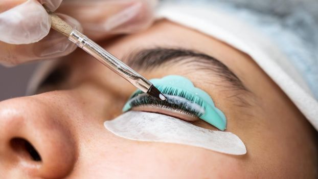 Close-up portrait of a woman on eyelash lamination procedure