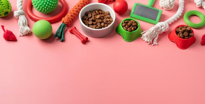 Pet care concept, various pet accessories and tools, toys, balls, brushes on pink background, flat lay