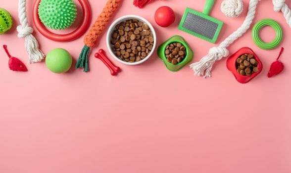 Pet care concept, various pet accessories and tools, toys, balls, brushes on pink background, flat lay