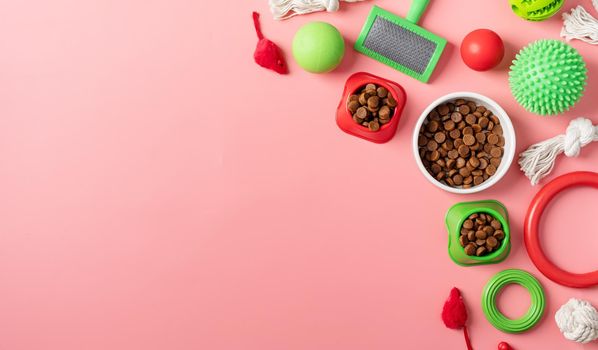Pet care concept, various pet accessories and tools, toys, balls, brushes on pink background, flat lay
