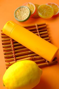 Close up of sunscreen cream in a orange container .