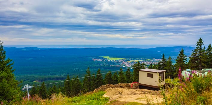 Wurmberg ride with the red gondola cable car railway with panorama view to mountain landscape of Braunlage Harz Goslar in Lower Saxony Germany.