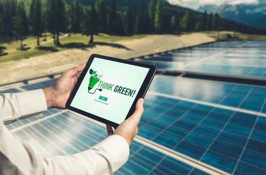 Green business transformation for environment saving and ESG business concept. Businessman using tablet to set corporate goal toward environmental friendly management and alternative clean energy use.