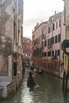 Venice, Italy - 10.12.2021: Traditional canal street with gondolas and boats in Venice, Italy. High quality photo