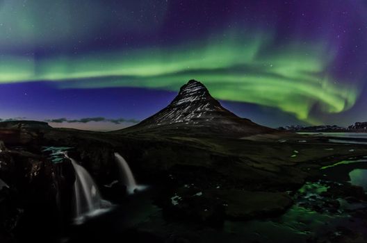 Aurora or northern lights next to Kirkjufell mountain in Iceland. Nature put on a light and dance show for us. We sat there in awe the whole time.