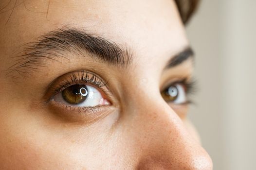 Close-up portrait of a young caucasian woman before eyelash lamination procedure