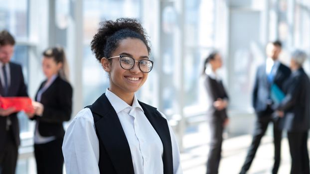 Portrait of a young mixed race business woman wearing glasses in office