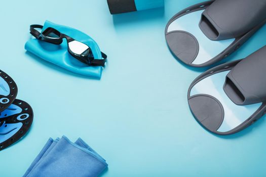 Sports equipment for swimming in the pool and open water on a blue background