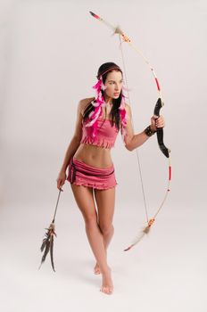 the slender woman in an Amazon costume with a bow and arrow in her hands