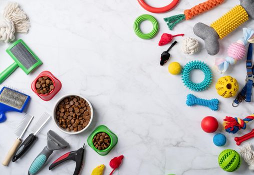 Pet care concept, various pet accessories and tools, toys, balls, brushes on white marble background, flat lay pattern