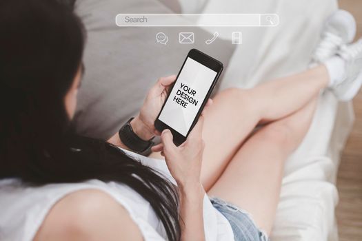 Asian woman sitting on sofa relaxing with cell phone white screen. young woman relax with social media only. women using the smartphone with search bar connect to social media, social network