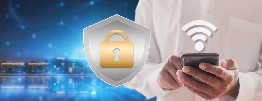 Businessman use smartphone contract to prevent probability of risks in cyber security and checking details in the phone. Padlock and shield hologram icons