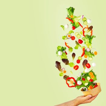flying summer salad. Greek salad: red tomatoes, pepper, lettuce, cucumber, carrot. food levitation, falling summer salad