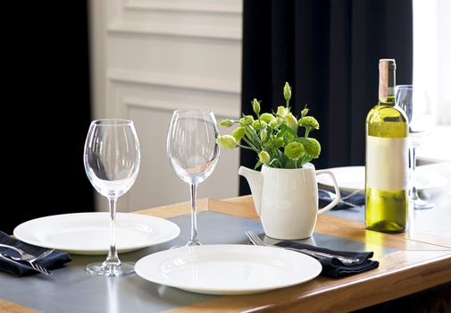 Served table in restaurant, focus on near glass and plate