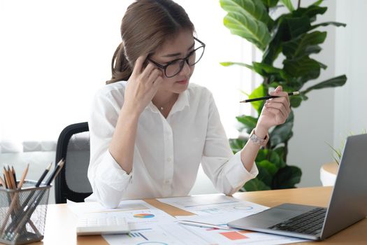 Asian Businesswoman working on laptop at her desk at the office..