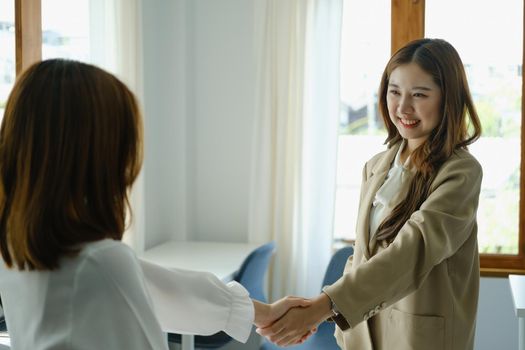 Young businesswoman collaborate with partners to increase their business investment network for Plans to improve quality next month in their office. agreement concept