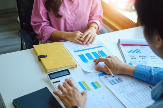 Teamwork concept, consultation, economist pointing budget, finance and investment documents, discussing and planning finances with advisors in conference room.