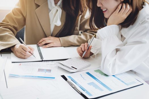 Negotiation, Analysis, Discussion, Asian woman economist and marketer pointing to a financial data sheet to plan investments to prevent risks and losses for the company.