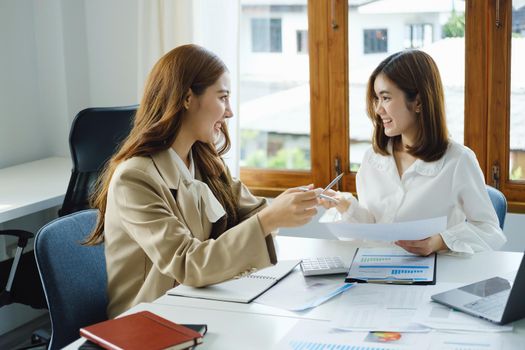 Negotiation, Analysis, Discussion, Portrait of an Asian woman economist and marketer pointing to a financial data sheet to plan investments to prevent risks and losses for the company.