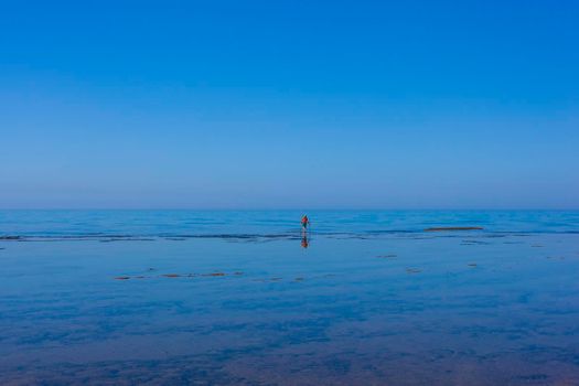 Scenic view of Sicily sea where an elderly man fishing with sticks