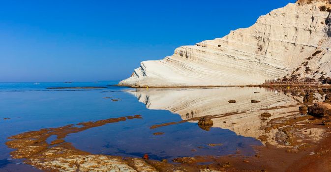 View of the limestone white cliffs with beach at the Scala dei Turchi in English Stair of the Turks or Turkish Steps near Realmonte in Agrigento province. Sicily, Italy