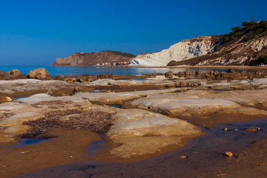 View of the limestone white cliffs with beach at the Scala dei Turchi in English Stair of the Turks or Turkish Steps near Realmonte in Agrigento province. Sicily, Italy