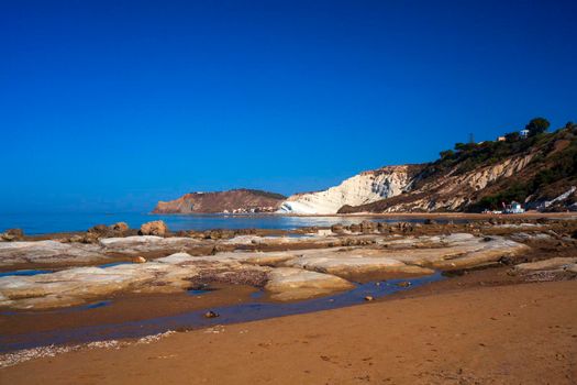 View of the limestone white cliffs with beach at the Scala dei Turchi in English Stair of the Turks or Turkish Steps near Realmonte in Agrigento province. Sicily, Italy