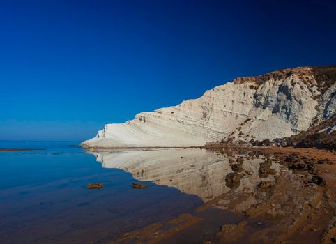 View of the limestone white cliffs with beach at the Scala dei Turchi in English Stair of the Turks or Turkish Steps near Realmonte in Agrigento province. Sicily, Italy